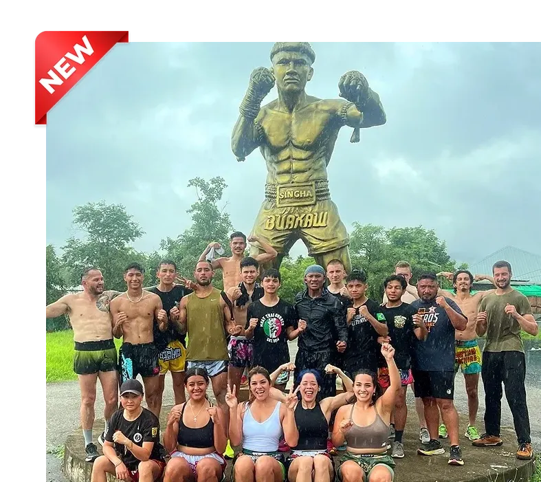 Buakaw standing proudly with his international students in front of the Gym.